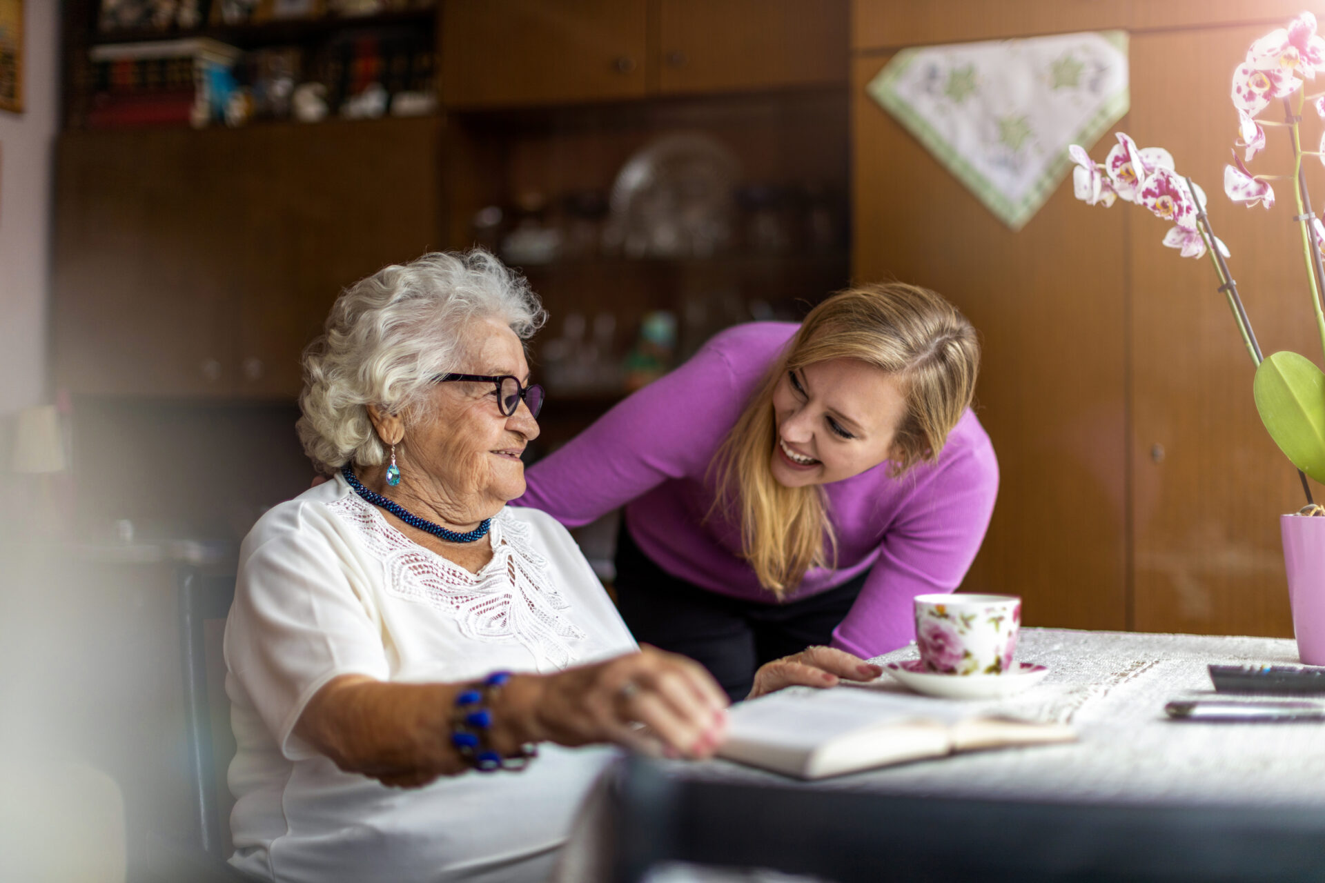 Carer with her arm around an elderly woman